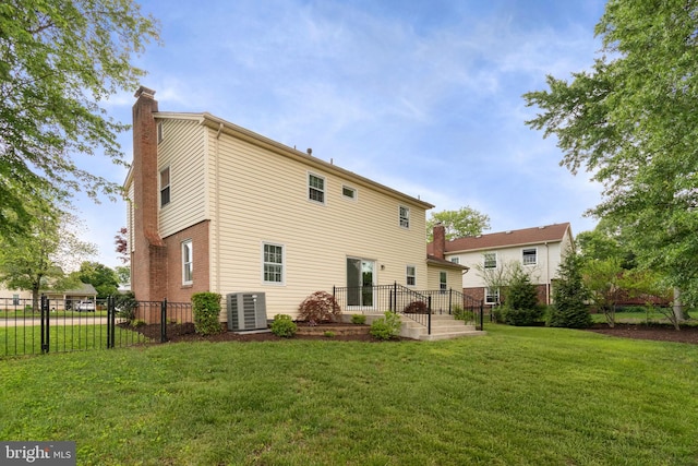 back of property featuring a chimney and central air condition unit