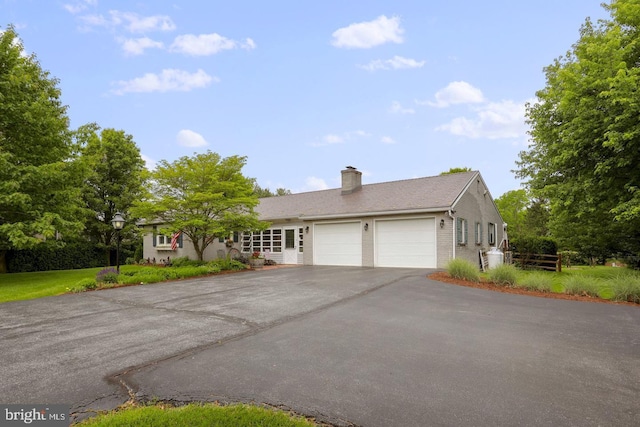 12511 Williamsport Pike, Greencastle, PA 17225 - ranch-style home featuring asphalt driveway, an attached garage, a chimney, and brick siding