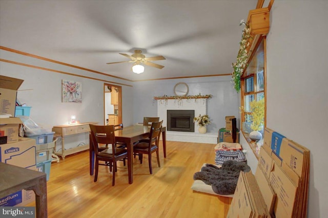 12511 Williamsport Pike, Greencastle, PA 17225 - dining area with a ceiling fan, wood finished floors, a fireplace, crown molding, and baseboards