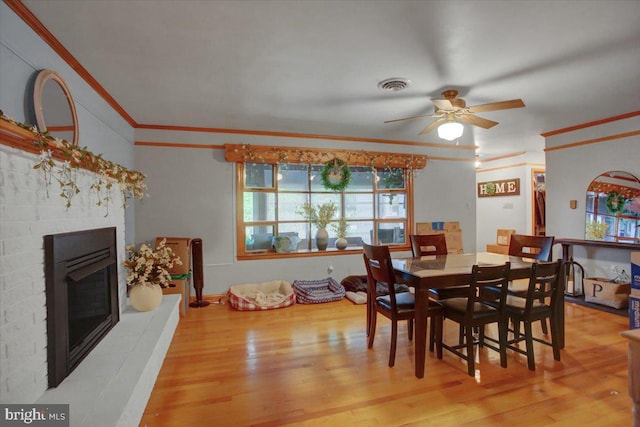 12511 Williamsport Pike, Greencastle, PA 17225 - dining area with ceiling fan, crown molding, wood finished floors, and a glass covered fireplace