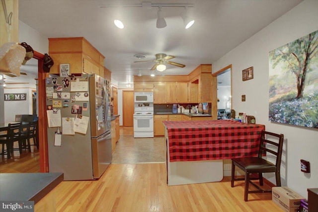 12511 Williamsport Pike, Greencastle, PA 17225 - kitchen featuring white appliances, a peninsula, a ceiling fan, track lighting, and light wood-style floors
