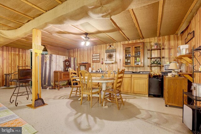 13450 Millstone Cir, Hancock, MD 21750 - dining space with wood walls, ceiling fan, and concrete floors