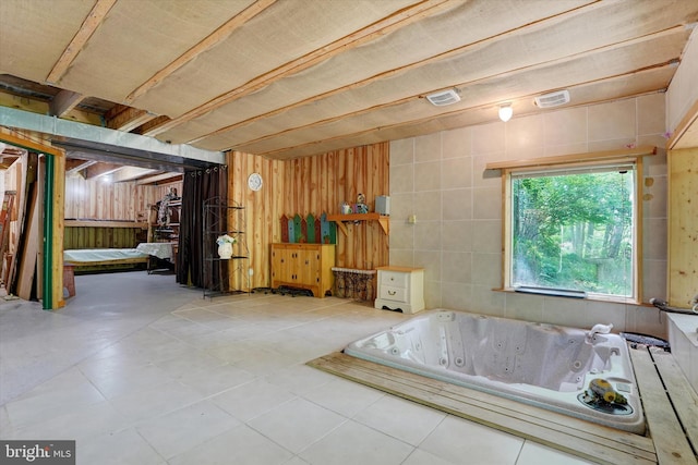 13450 Millstone Cir, Hancock, MD 21750 - bathroom with a jetted tub, wood walls, and tile patterned floors
