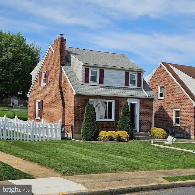 view of front of home featuring a chimney, roof with shingles, and brick siding