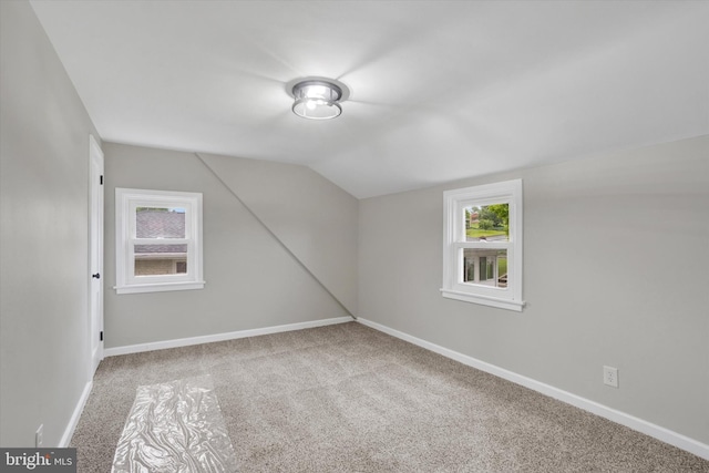 bonus room featuring carpet flooring, lofted ceiling, and baseboards