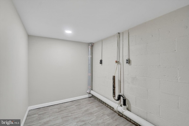 unfinished below grade area with baseboards and recessed lighting