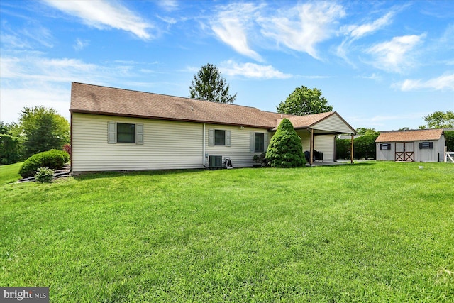 30 Foxanna Dr, Carlisle, PA 17015 - rear view of property featuring an outdoor structure, a storage unit, a yard, and central AC unit