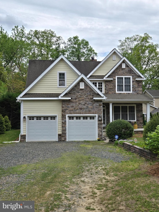 31667 W Edge Rd, Millington, MD 21651 - view of front of house with dirt driveway, stone siding, an attached garage, a shingled roof, and a chimney