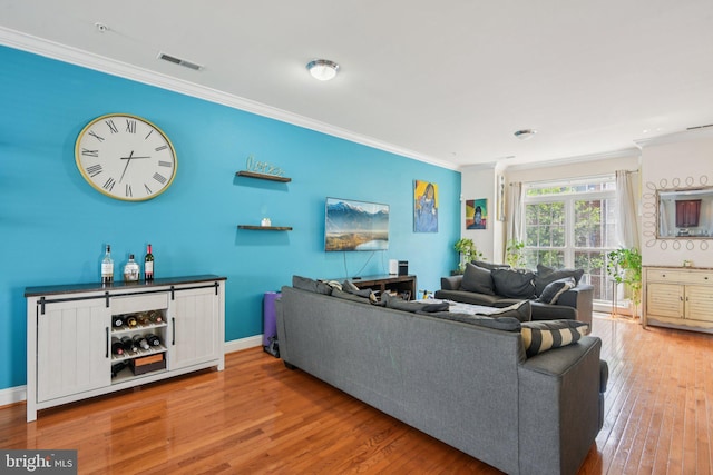 806 Ryan St, Baltimore, MD 21230 - living room featuring crown molding, wood finished floors, and a dry bar