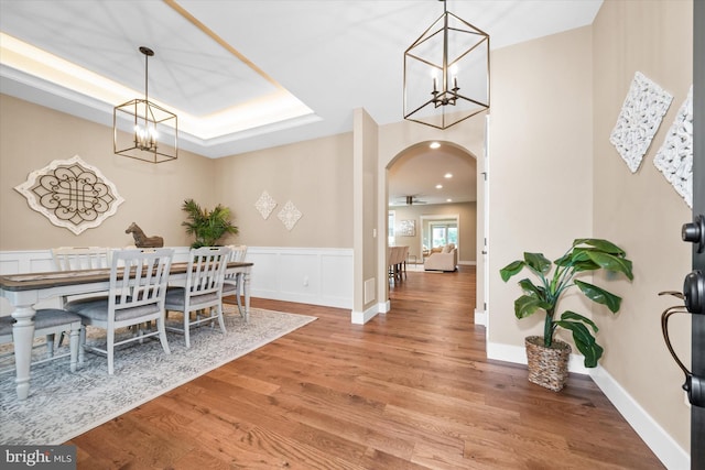 843 Summer Breeze Path, Cochranville, PA 19330 - dining space with a chandelier, arched walkways, light wood-type flooring, and wainscoting