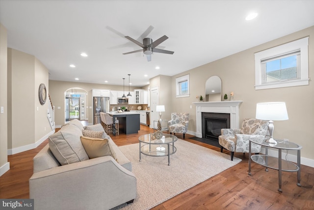 843 Summer Breeze Path, Cochranville, PA 19330 - living room with plenty of natural light, a fireplace with flush hearth, arched walkways, baseboards, and recessed lighting