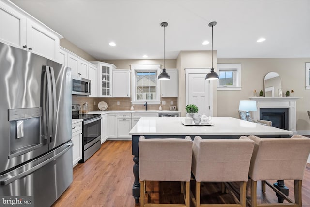 843 Summer Breeze Path, Cochranville, PA 19330 - kitchen featuring stainless steel appliances, light countertops, a sink, glass insert cabinets, and backsplash