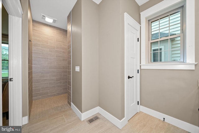 843 Summer Breeze Path, Cochranville, PA 19330 - bathroom featuring a tile shower, healthy amount of natural light, and baseboards