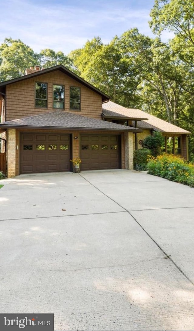 8323 Morningside Dr, Manassas, VA 20112 - view of front of property featuring concrete driveway and a chimney