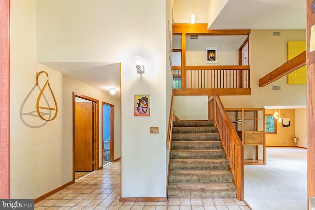 8323 Morningside Dr, Manassas, VA 20112 - stairway featuring a high ceiling, baseboards, and tile patterned flooring