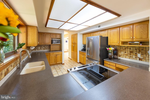 8323 Morningside Dr, Manassas, VA 20112 - kitchen featuring stainless steel fridge with ice dispenser, a sink, dark countertops, stove, and backsplash