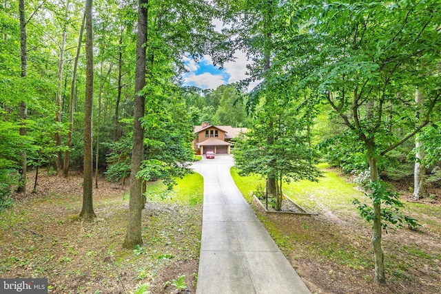 8323 Morningside Dr, Manassas, VA 20112 - obstructed view of property featuring driveway and a forest view