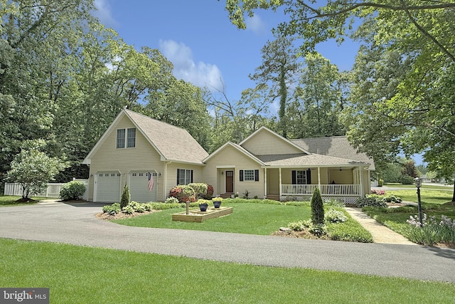 10 Greystone Dr, Lewes, DE 19958 - view of front of property featuring covered porch, a front yard, asphalt driveway, an attached garage, and roof with shingles