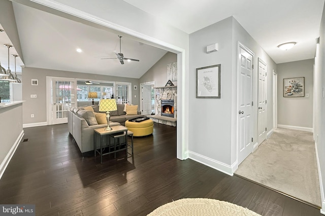 10 Greystone Dr, Lewes, DE 19958 - living area featuring lofted ceiling, baseboards, ceiling fan, a fireplace, and dark wood-style floors