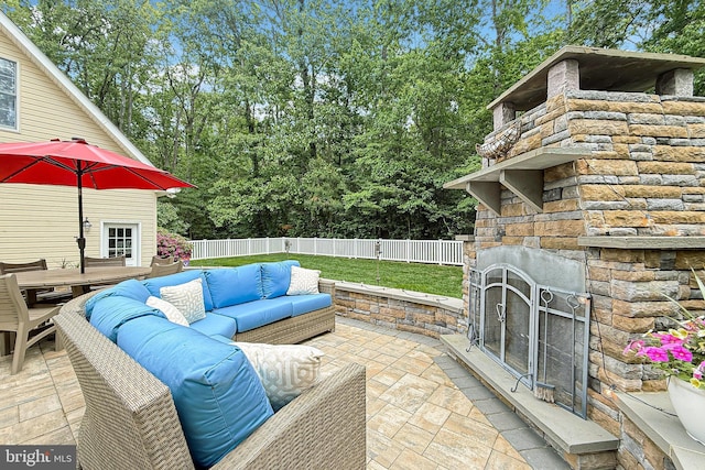 10 Greystone Dr, Lewes, DE 19958 - view of patio / terrace with an outdoor living space with a fireplace, a fenced backyard, and view of scattered trees