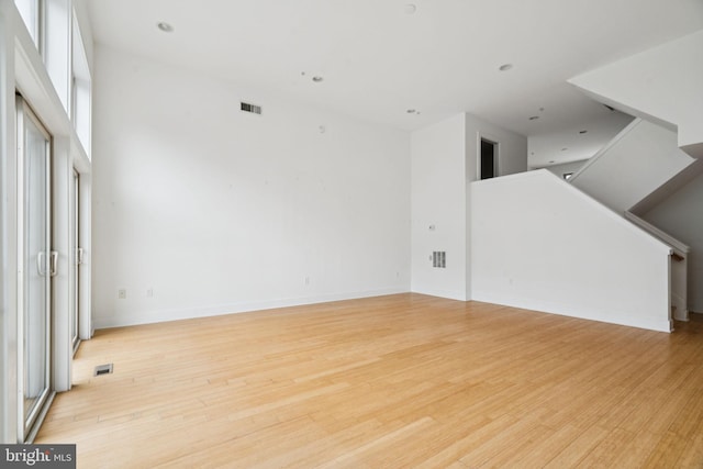 315 Dupont St, Philadelphia, PA 19128 - unfurnished living room with light wood-style flooring, plenty of natural light, and stairs