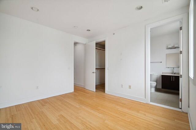 315 Dupont St, Philadelphia, PA 19128 - unfurnished bedroom with light wood-type flooring, recessed lighting, a closet, ensuite bath, and a walk in closet