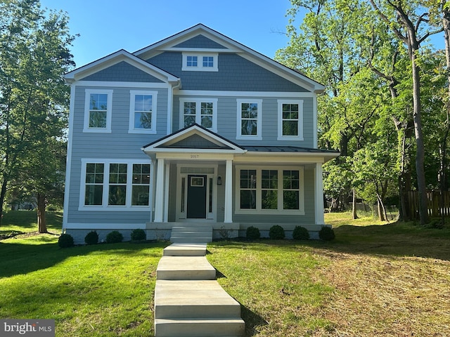view of front facade featuring a front lawn and a standing seam roof