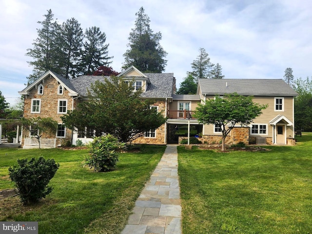 1148 Bodine Rd, Chester Springs, PA 19425 - view of front of property featuring stone siding, a front yard, a balcony, and central air condition unit