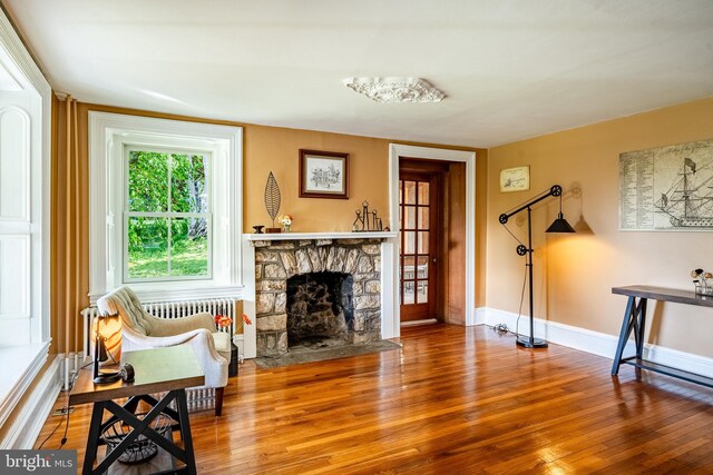 1148 Bodine Rd, Chester Springs, PA 19425 - living area with wood finished floors, a fireplace, and baseboards