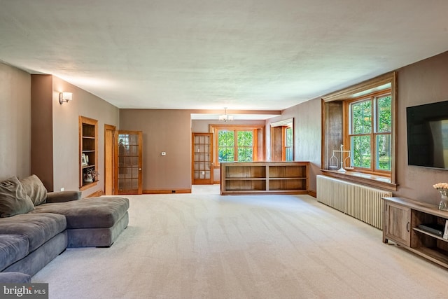 1148 Bodine Rd, Chester Springs, PA 19425 - living area with radiator, light carpet, and baseboards