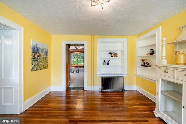 1148 Bodine Rd, Chester Springs, PA 19425 - unfurnished dining area featuring radiator, dark wood-type flooring, a textured ceiling, and baseboards