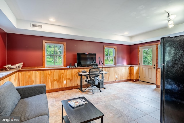 1148 Bodine Rd, Chester Springs, PA 19425 - living area featuring a tray ceiling, healthy amount of natural light, a wainscoted wall, baseboards, and wood walls
