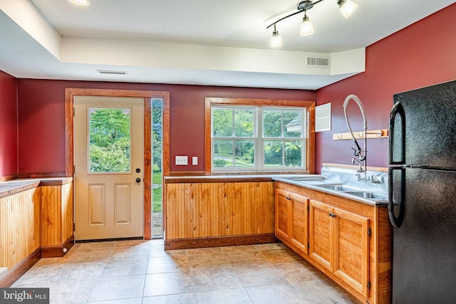 1148 Bodine Rd, Chester Springs, PA 19425 - kitchen featuring freestanding refrigerator, healthy amount of natural light, a wainscoted wall, a sink, and brown cabinets