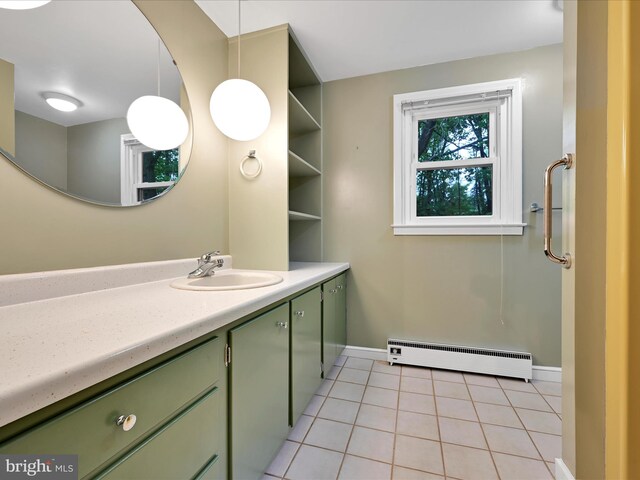 bathroom with a baseboard heating unit, vanity, tile patterned flooring, and baseboards
