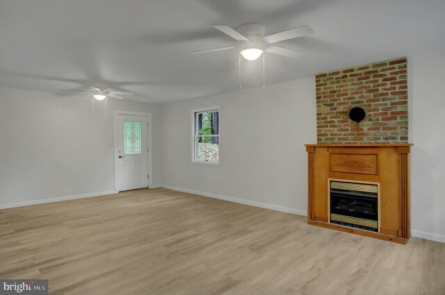 7 Cross Trl, Fairfield, PA 17320 - unfurnished living room with a ceiling fan, a large fireplace, light wood finished floors, and baseboards