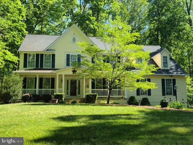 colonial house with a porch and a front lawn