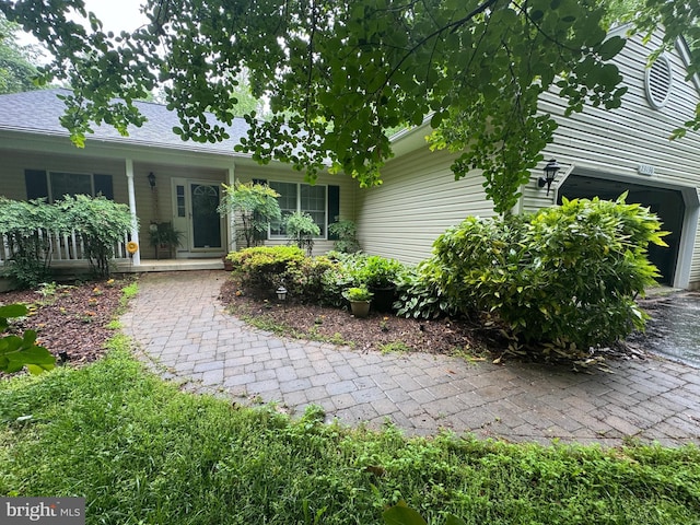 view of front of home featuring a garage and a porch