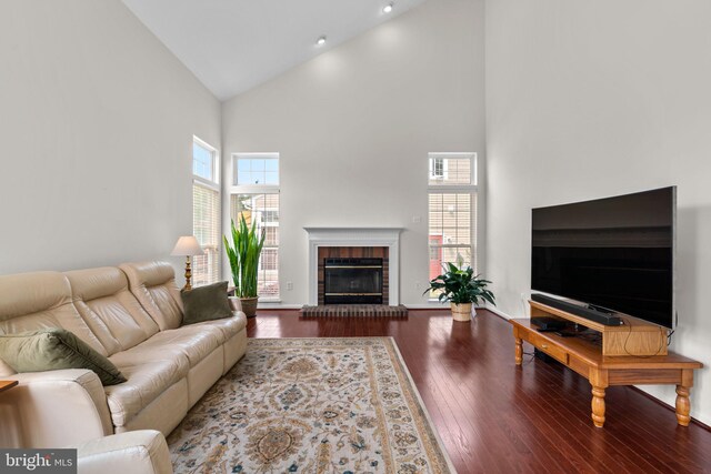 11221 Chaucers Ridge Ct, Laurel, MD 20723 - living area with high vaulted ceiling, plenty of natural light, wood finished floors, a brick fireplace, and baseboards