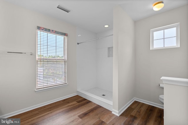 11221 Chaucers Ridge Ct, Laurel, MD 20723 - bathroom featuring toilet, tiled shower, wood finished floors, baseboards, and recessed lighting