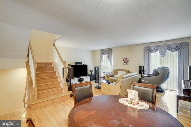 5941 Powells Landing Rd, Burke, VA 22015 - dining area featuring healthy amount of natural light, wood finished floors, stairs, and ornamental molding