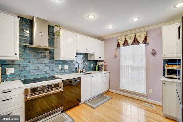 5941 Powells Landing Rd, Burke, VA 22015 - kitchen with black appliances, a sink, wall chimney range hood, backsplash, and white cabinets