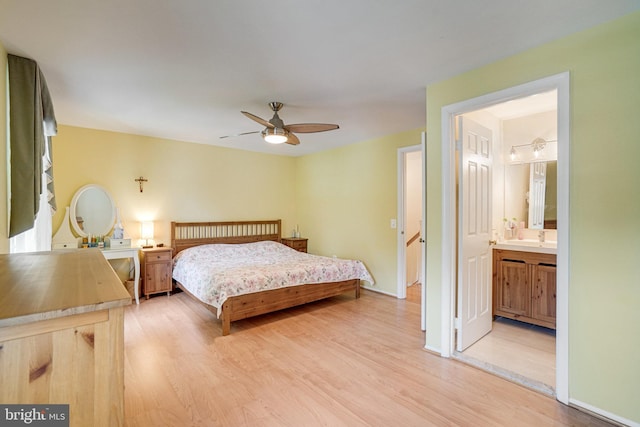 5941 Powells Landing Rd, Burke, VA 22015 - bedroom with light wood-type flooring, connected bathroom, a sink, and ceiling fan