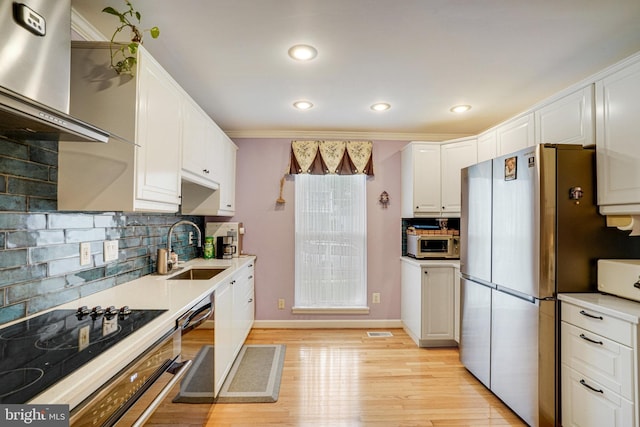 5941 Powells Landing Rd, Burke, VA 22015 - kitchen with a sink, stainless steel appliances, wall chimney exhaust hood, white cabinets, and backsplash