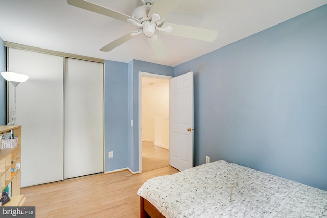 5941 Powells Landing Rd, Burke, VA 22015 - bedroom with light wood finished floors, a ceiling fan, a closet, and baseboards