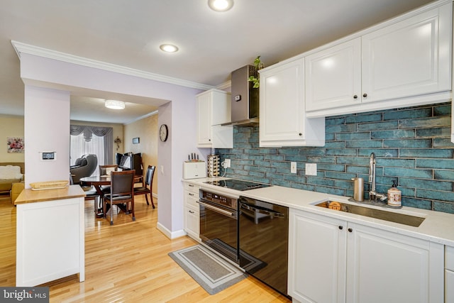 5941 Powells Landing Rd, Burke, VA 22015 - kitchen with a sink, black appliances, white cabinets, light countertops, and light wood-style flooring