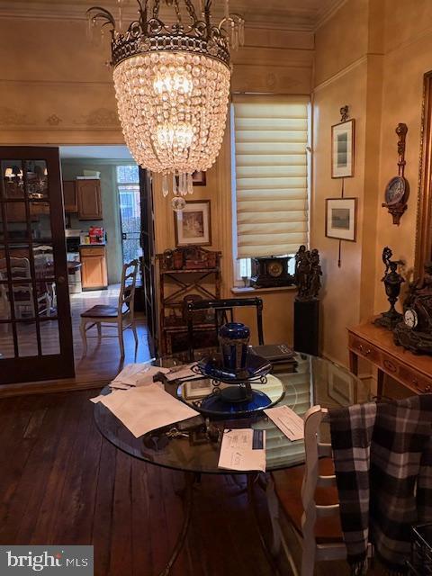 dining room featuring a chandelier and dark wood-type flooring