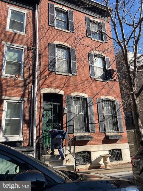 view of front of home featuring brick siding
