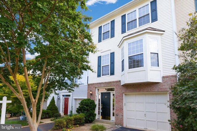 9435 Silver Meteor Ct, Manassas Park, VA 20111 - townhome / multi-family property featuring brick siding and an attached garage