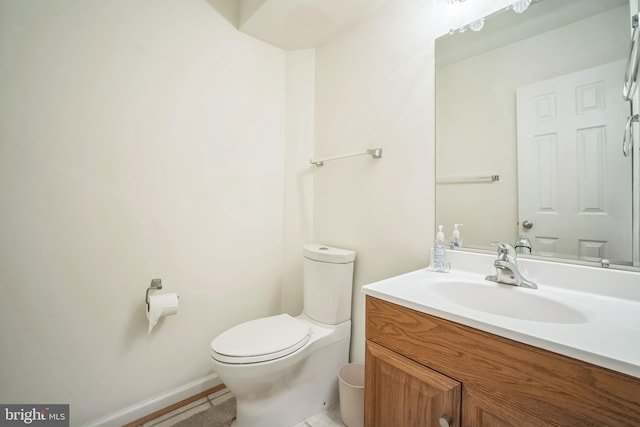 9435 Silver Meteor Ct, Manassas Park, VA 20111 - bathroom with toilet, vanity, and baseboards