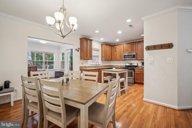9435 Silver Meteor Ct, Manassas Park, VA 20111 - dining area with crown molding, light wood-style floors, baseboards, plenty of natural light, and recessed lighting